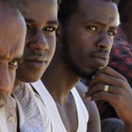 Somali men, who were fleeing Somalia and were captured by anti-Gaddafi fighters in Kofra city to the south of Benghazi, sit at the headquarters of the Libyan Red Crescent in Benghazi