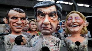 FILE PHOTO: A worker puts the final touches to a giant figure of Francois Fillon, member of Les Republicains political party and 2017 presidential candidate of the French centre-right during preparations for the carnival parade in Nice